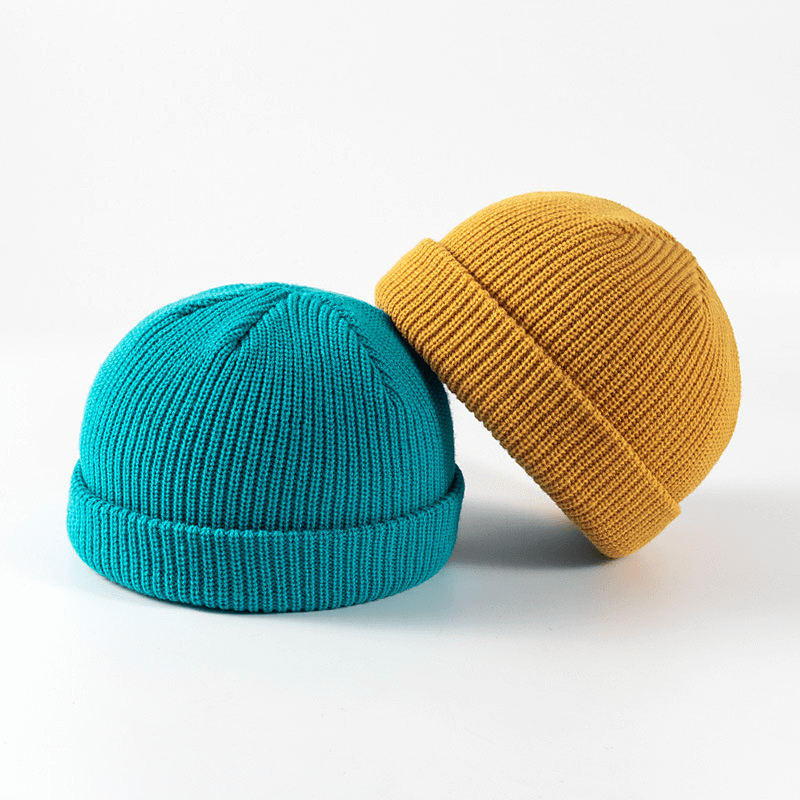 Fornitore all'ingrosso di berretti da pescatore invernali lavorati a maglia con teschio con bordo arrotolato Trawler per donna uomo