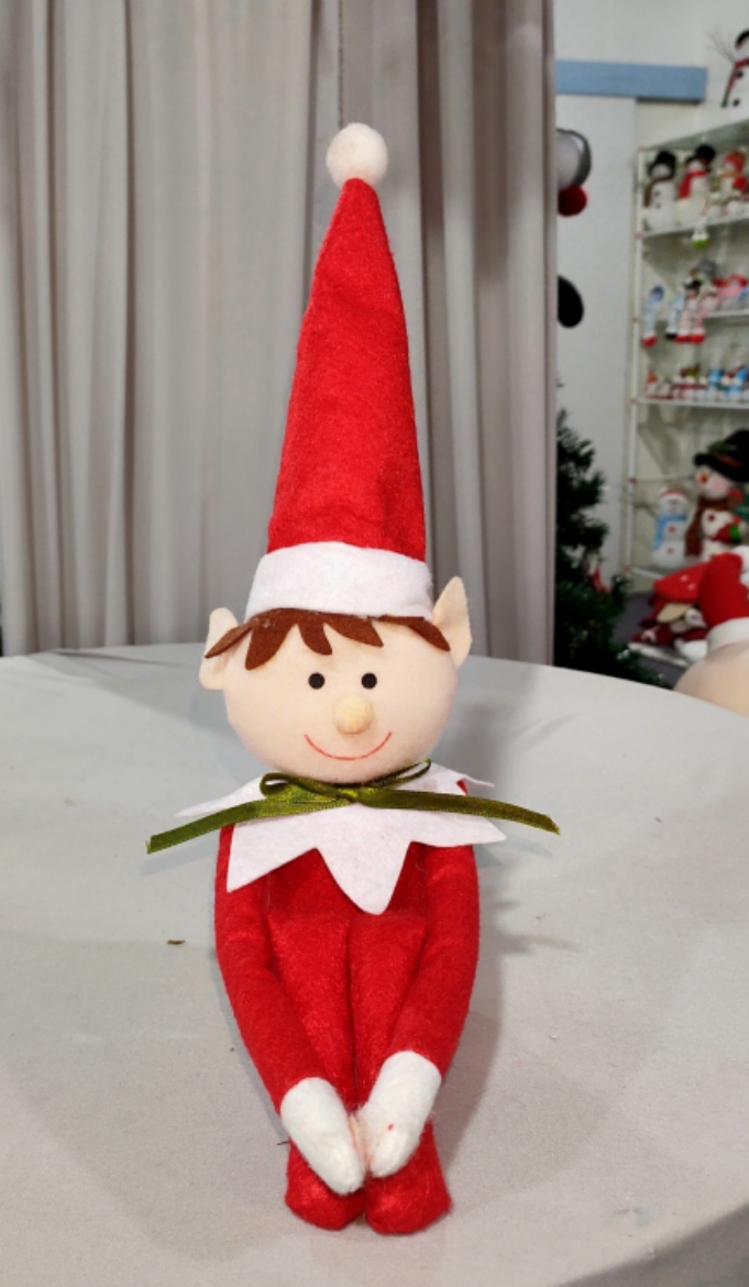 Bambola elfo di Natale: aggiunta festosa alla tua libreria