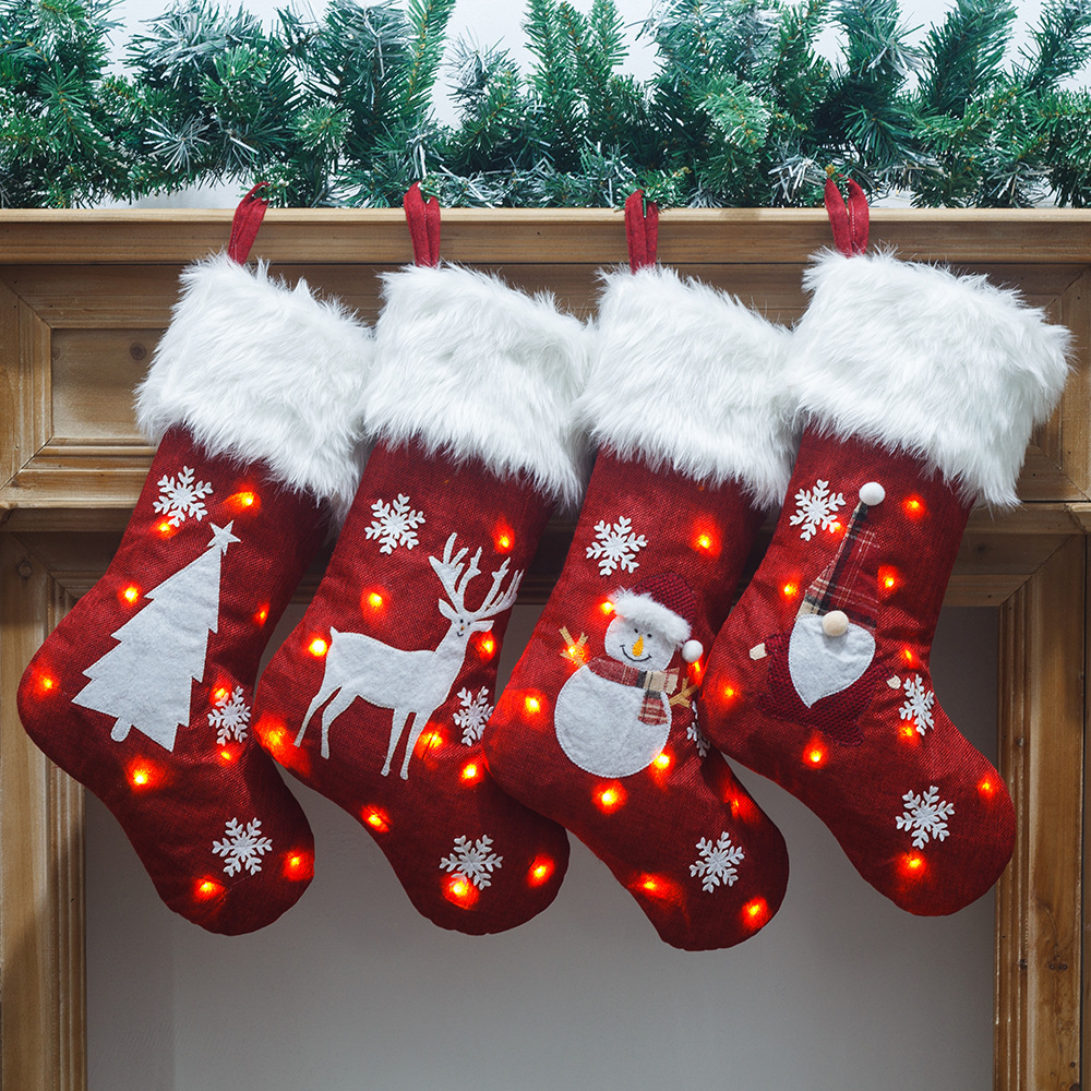 Calza natalizia luminosa con fiocco di neve rosso a LED